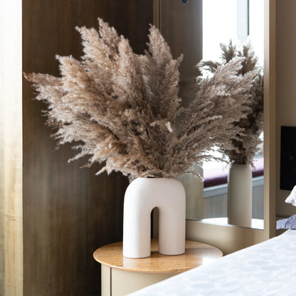 Pampas Grass Sticks in a White U Shaped Vase